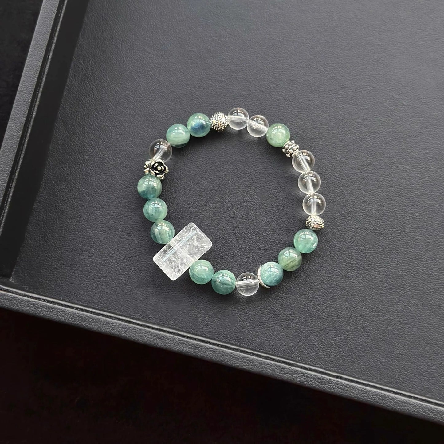 White Azeztulite & Blue Green Kyanite & Clear Quartz Bracelet on a dark surface