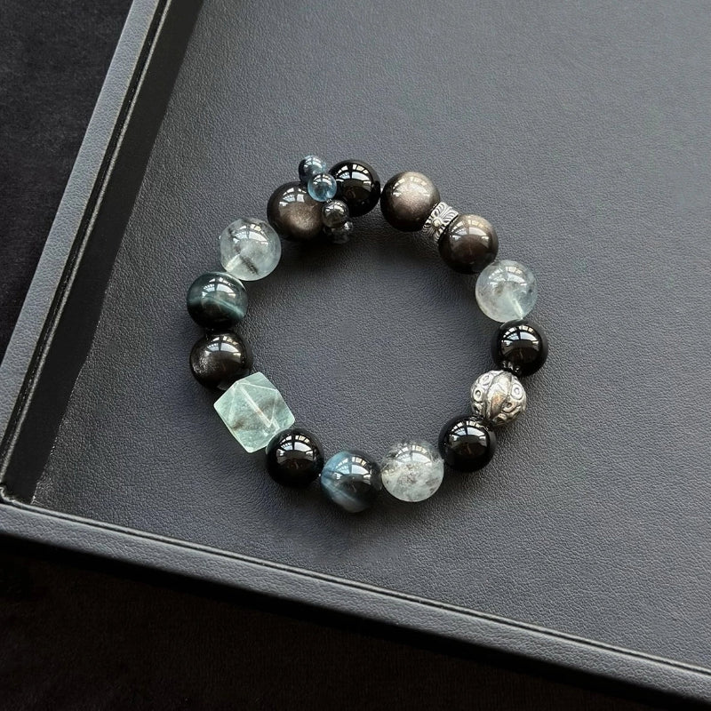 Healing crystal bracelet featuring Black Flash Aquamarine, Blue Tiger’s Eye, and Obsidian – supports protection, insight, and emotional calm.