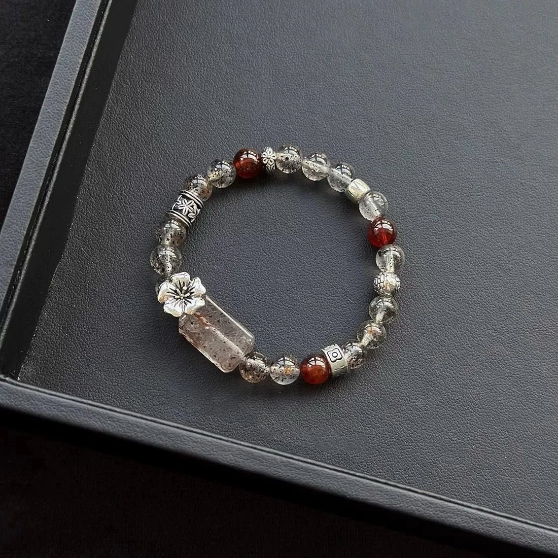 Healing crystal bracelet featuring Black Mica Hematoid Quartz, Strawberry Quartz, and Garnet – supports emotional strength, grounding, and love energy.
