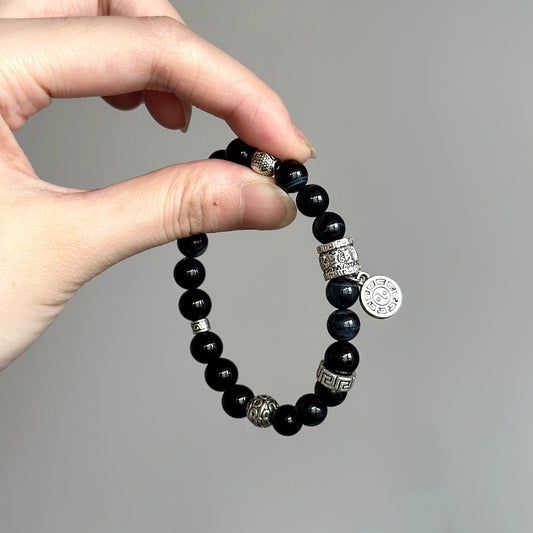 Beaded bracelet made with Blue Tiger’s Eye and Black Agate – ideal for stress relief, protection, and confidence.