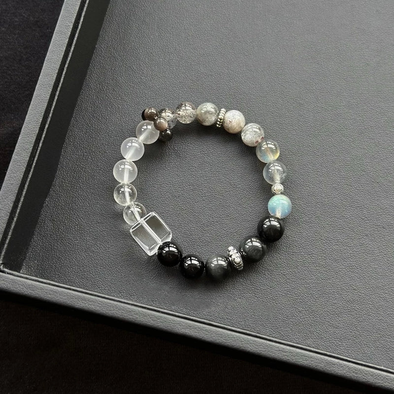 Healing crystal bracelet featuring Clear Quartz, Grey Moonstone, and Silver Obsidian – supports clarity, intuition, and energetic protection.