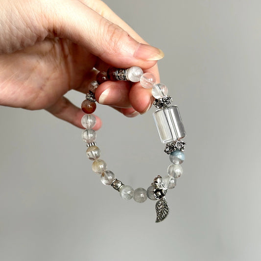 Beaded crystal bracelet made with Clear Quartz and Rabbit Hair Quartz – ideal for feminine energy balance and spiritual clarity.