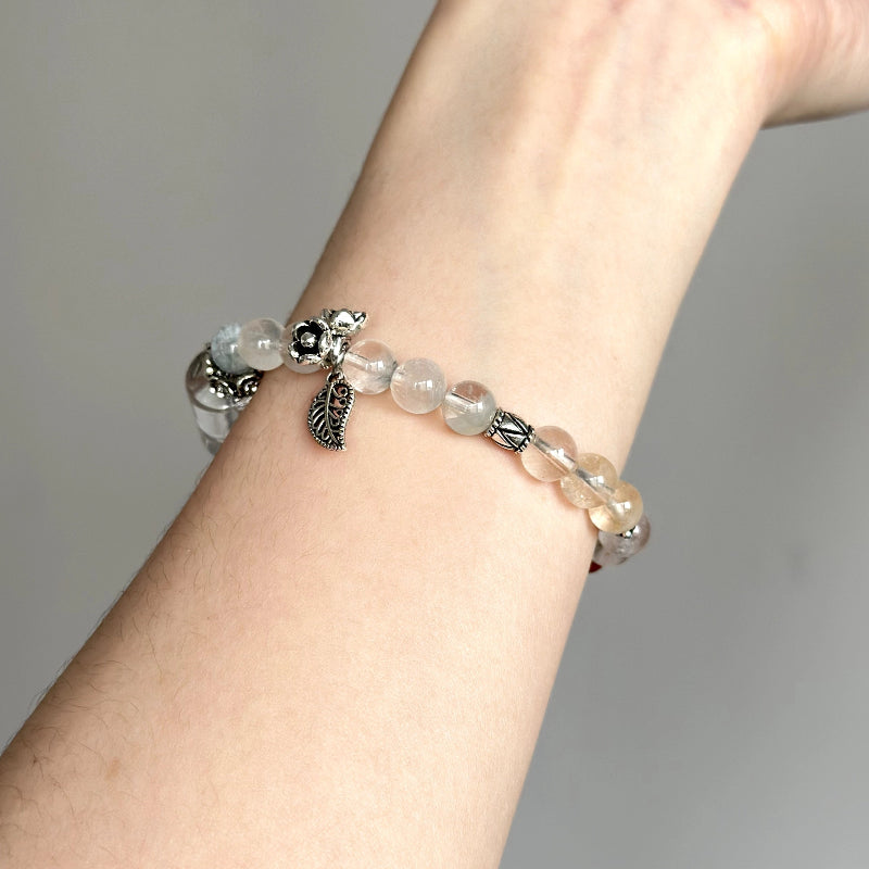 Elegant beaded bracelet featuring Clear Quartz and Rabbit Hair Quartz – handmade crystal jewelry for healing and mindfulness.