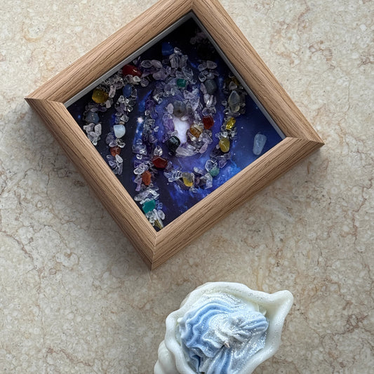 Completed Square Universe Crystal Art displayed as small desk art next to an aesthetic candle.