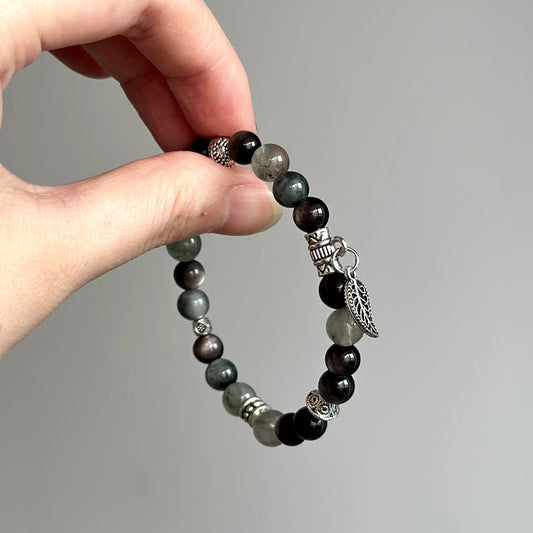 Crystal healing bracelet with Hawk’s Eye and Silver Obsidian – enhances focus, insight, and emotional strength.