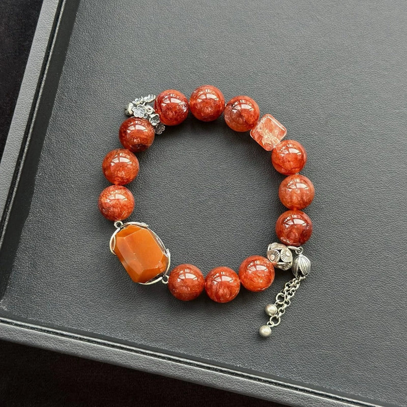 Healing crystal bracelet featuring Orange Rabbit Hair Quartz and Red Hematoid Quartz – supports vitality, grounding, and emotional strength.