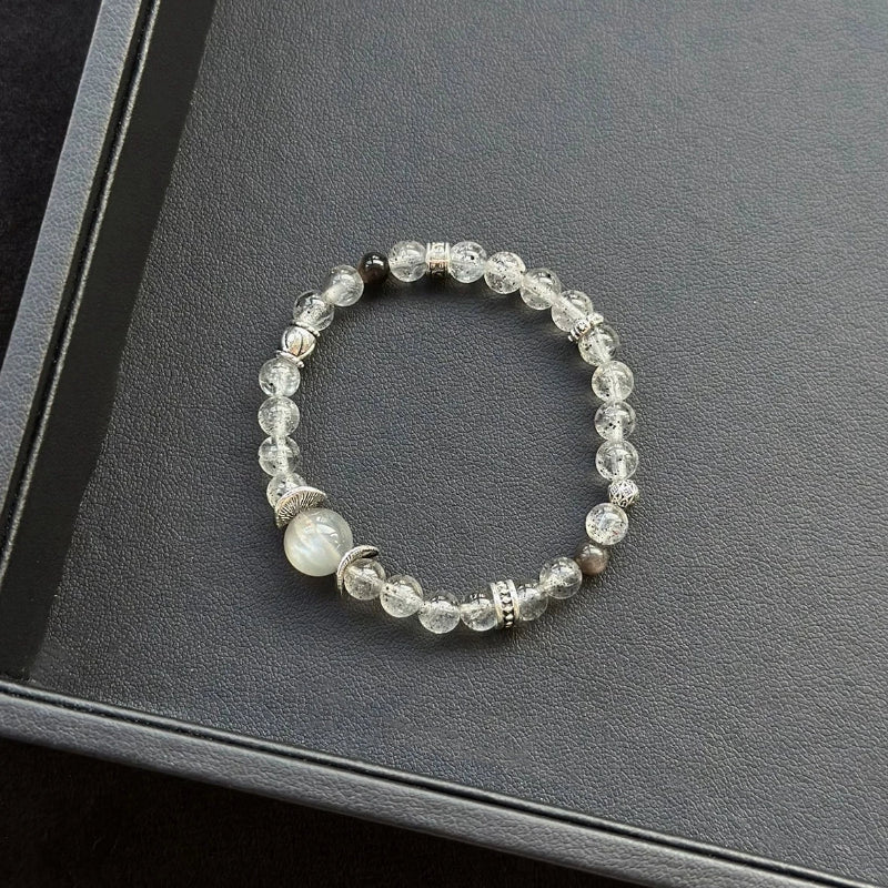 Healing crystal bracelet featuring Skeletal Moonstone, Black Mica, and Silver Obsidian – supports intuition, grounding, and energetic protection.