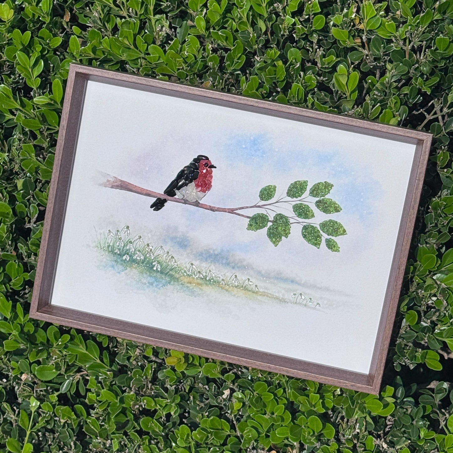 Elegant small space desk art featuring a crystal bird, placed in a modern garden setting.