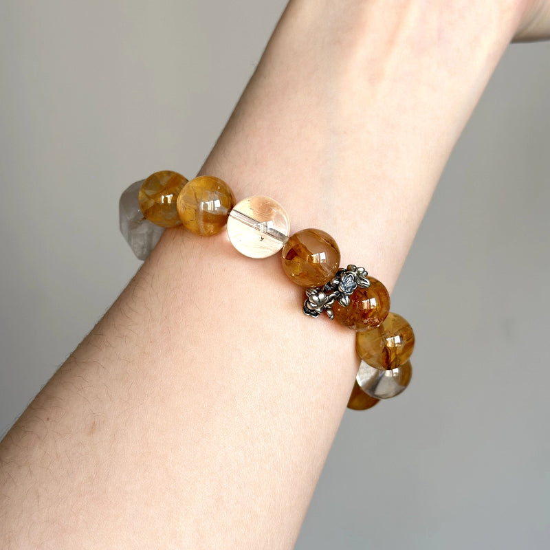 Unique beaded crystal bracelet featuring White Phantom, Yellow Hematite Quartz and Rabbit Hair, for healing and focus.