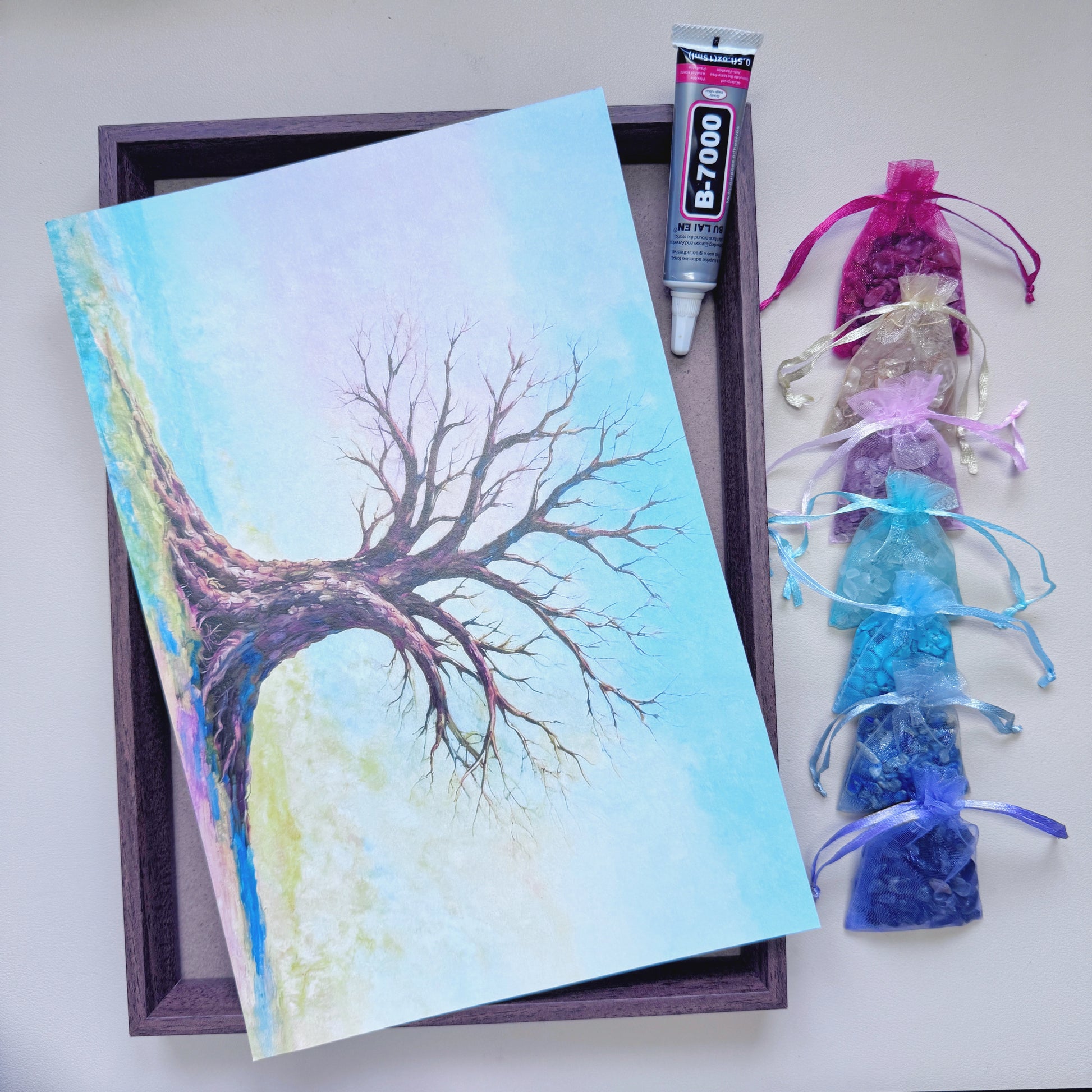 A4 size wood-grain framed Tree of Life art canvas paired with neatly arranged natural gemstone chips on the right side for beginner crystal crafting.