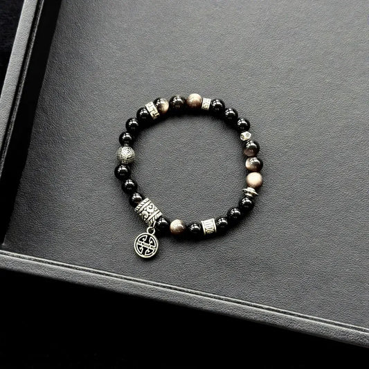 Black Agate & Silver Obsidian Bracelet on a gray surface