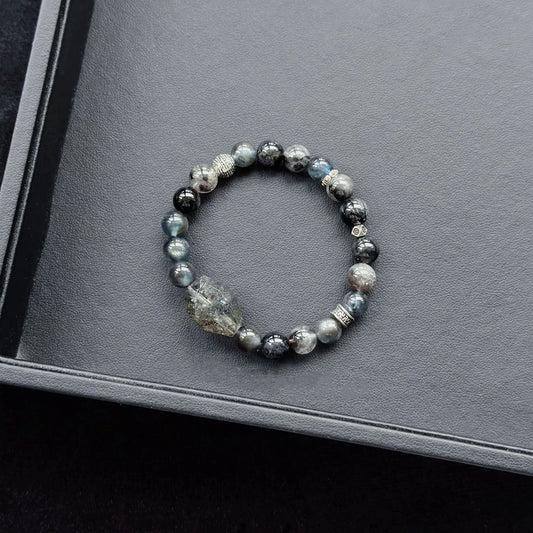 Black Rutilated Quartz & Black Flash Aquamarine & Silver Obsidian & Herkimer Diamond Bracelet on a dark surface