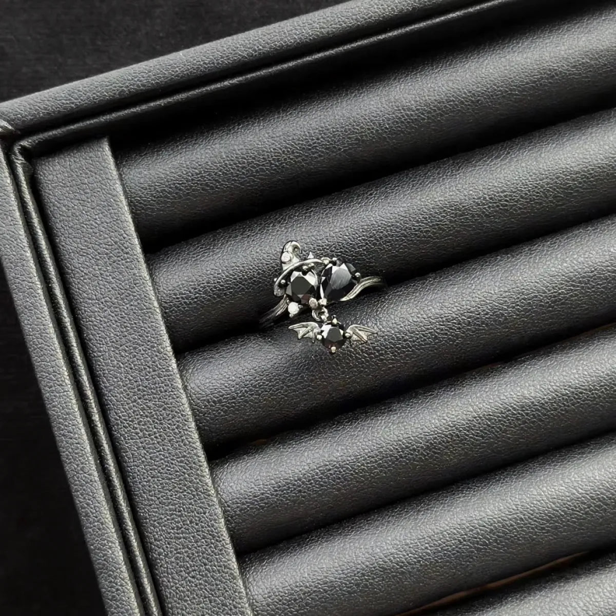 Black Spinel “Halloween Gun” Sterling Silver Ring on a textured gray surface