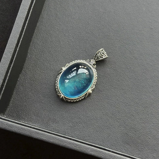 Devil Blue Aquamarine Sterling Silver Pendant on a gray surface