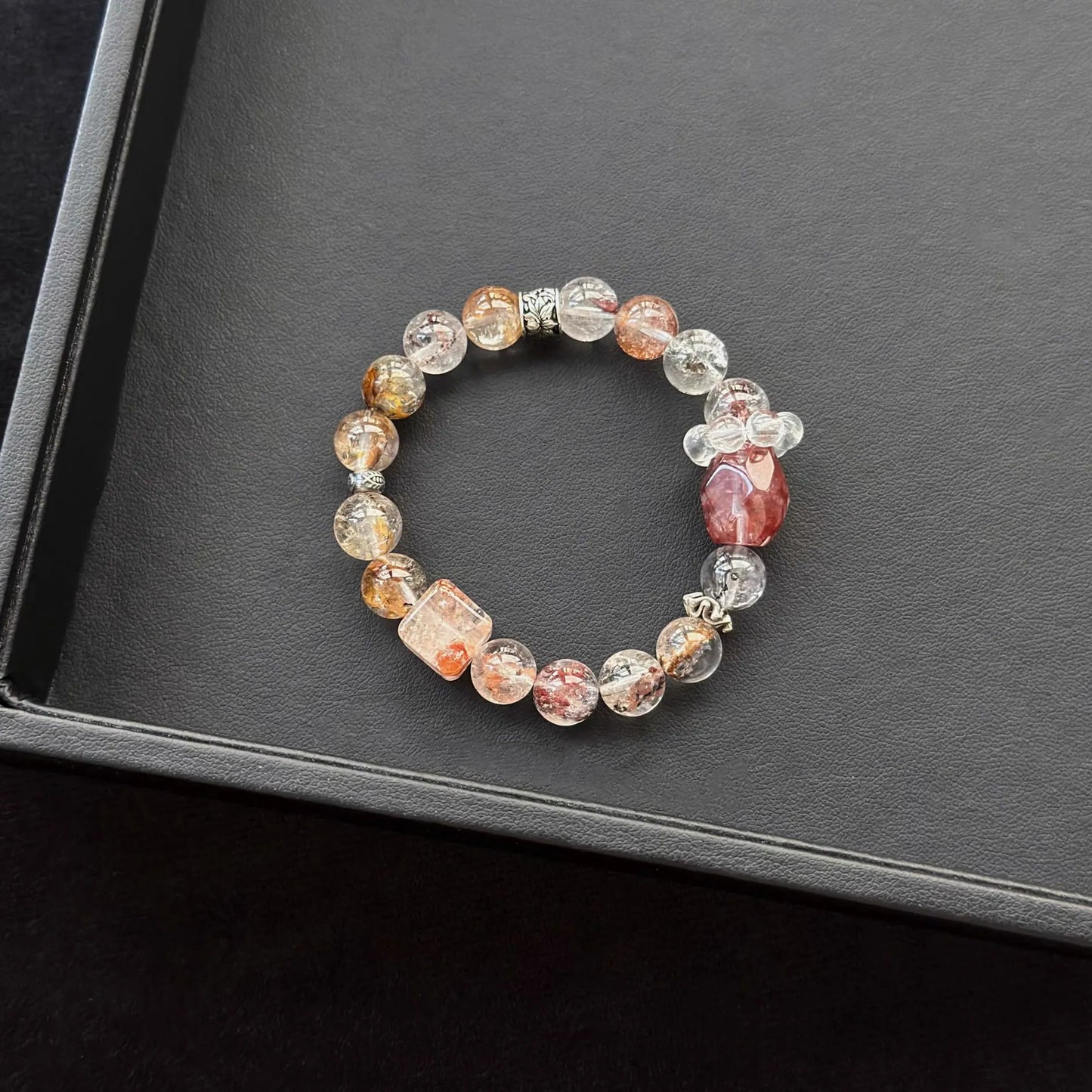Hematoid Quartz with Herkimer Diamond & Red Hematoid Quartz & Dendritic Quartz Bracelet on a dark surface