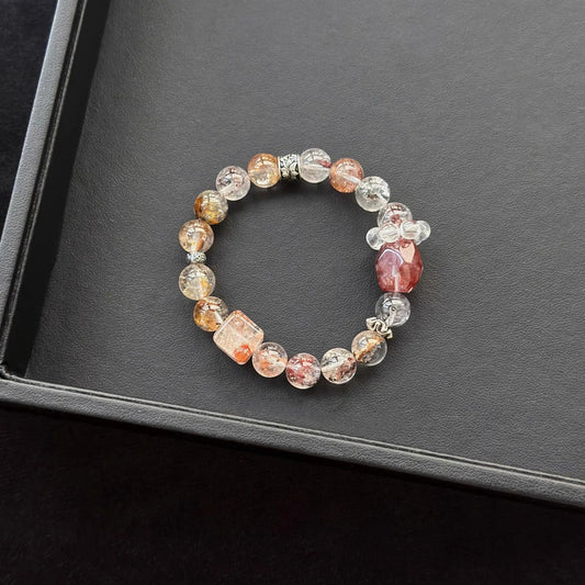 Hematoid Quartz with Herkimer Diamond & Red Hematoid Quartz & Dendritic Quartz Bracelet on a dark surface