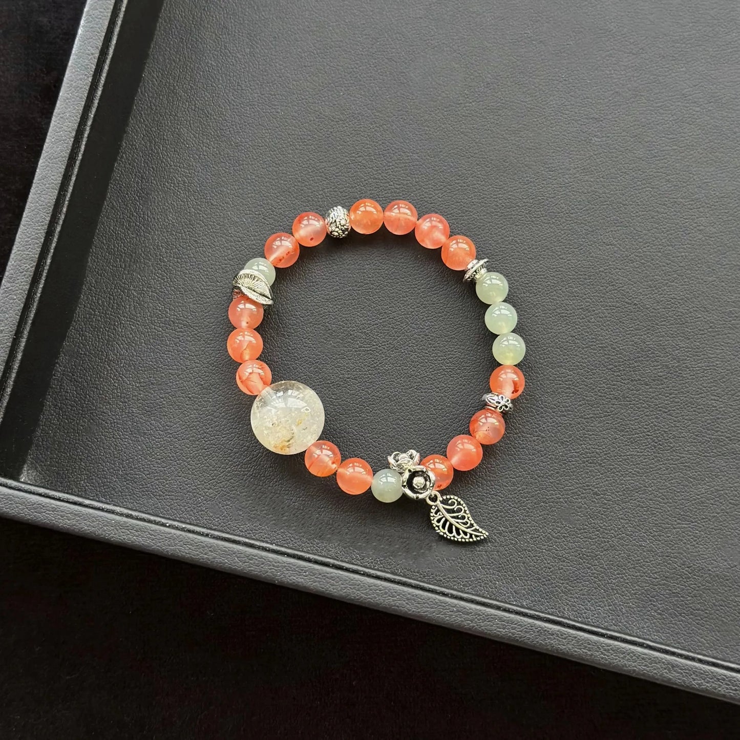 Rabbit Hair Quartz with Phantom Quartz & Ice Floating South Red Agate & Jasper Bracelet on a dark surface