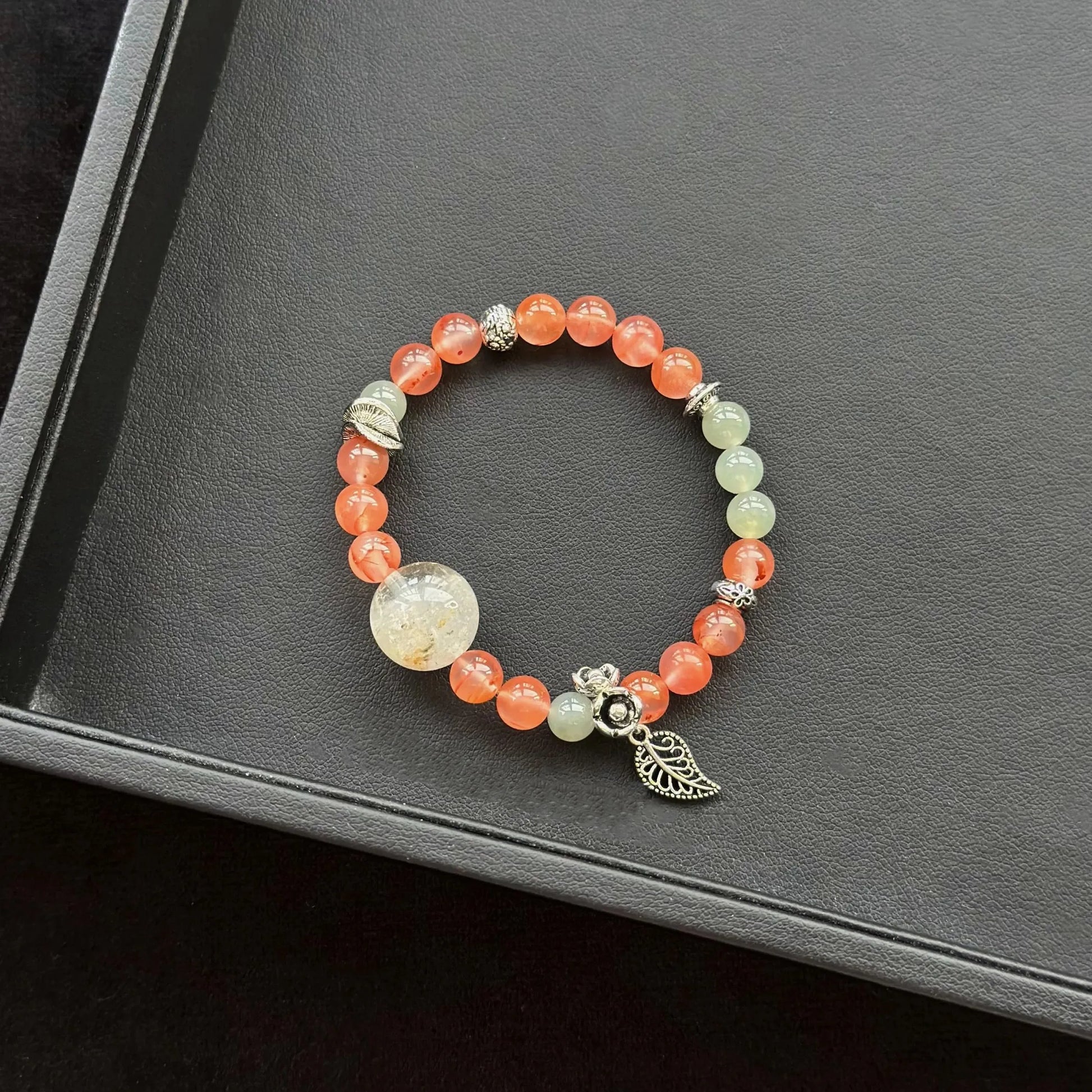 Rabbit Hair Quartz with Phantom Quartz & Ice Floating South Red Agate & Jasper Bracelet on a dark surface