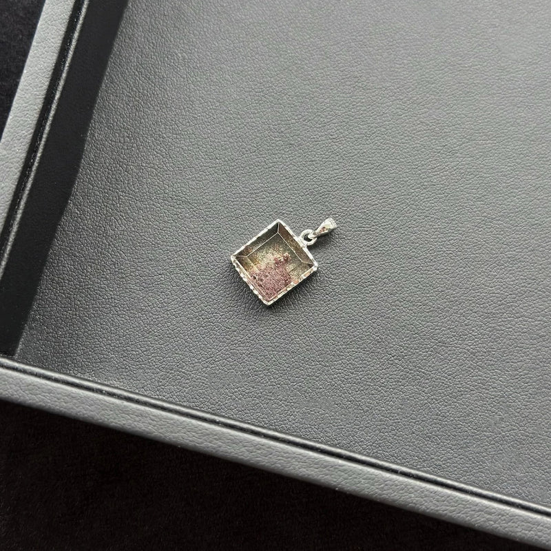 Rectangle Four Season Azeztulite Sterling Silver Pendant on a gray surface