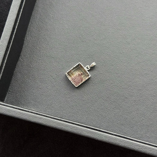 Rectangle Four Season Azeztulite Sterling Silver Pendant on a gray surface