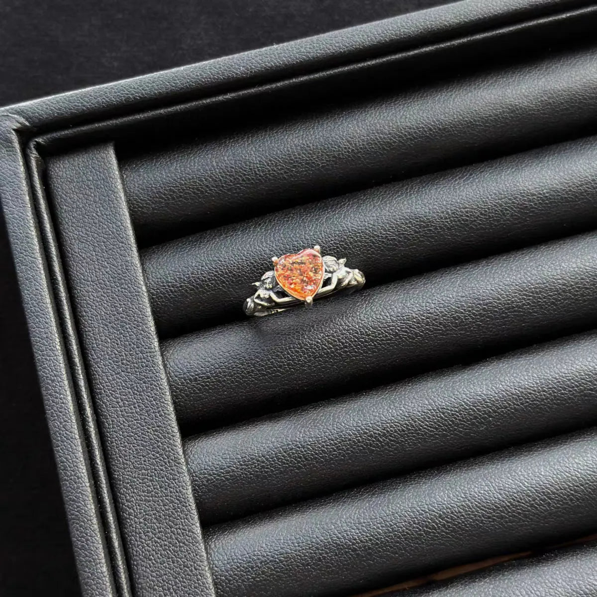 Sunstone “Heart Angel” Sterling Silver Ring on a gray jewelry box.