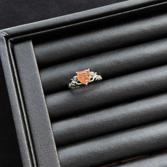 Sunstone “Heart Angel” Sterling Silver Ring on a gray jewelry box.