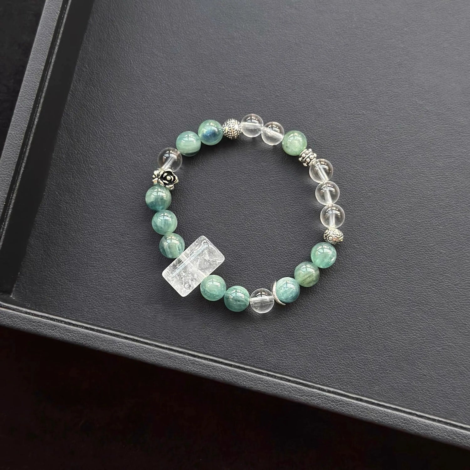 White Azeztulite & Blue Green Kyanite & Clear Quartz Bracelet on a dark surface