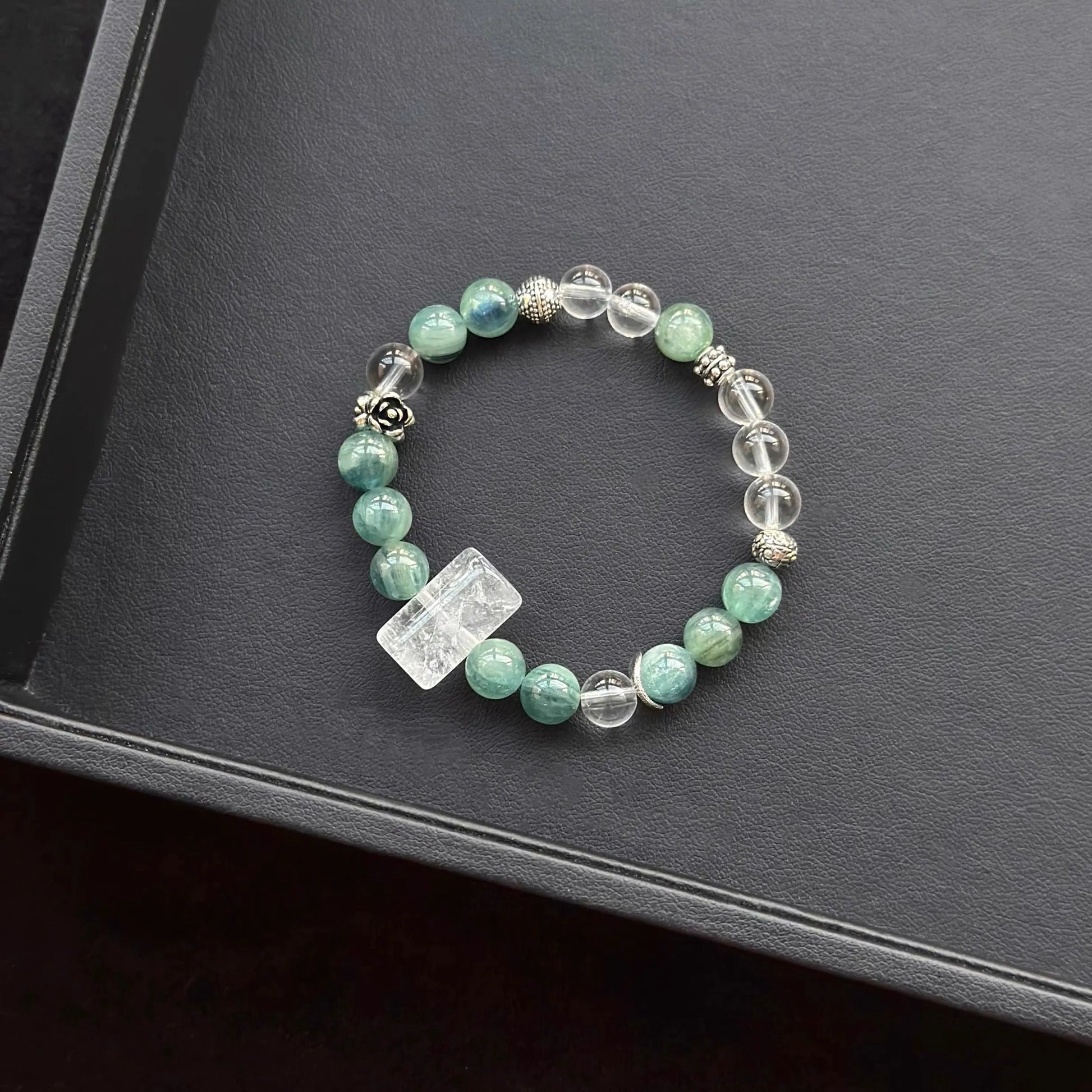White Azeztulite & Blue Green Kyanite & Clear Quartz Bracelet on a dark surface