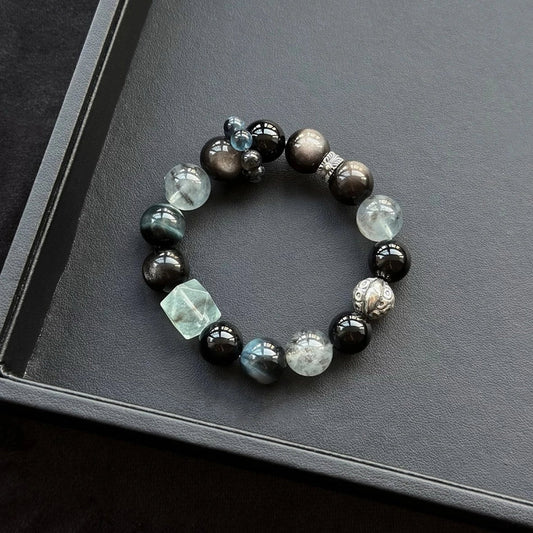 Healing crystal bracelet featuring Black Flash Aquamarine, Blue Tiger’s Eye, and Obsidian – supports protection, insight, and emotional calm.