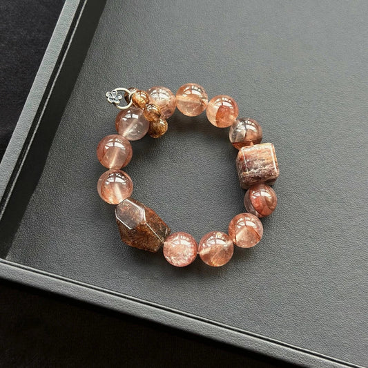 Healing crystal bracelet featuring Black-Gold Super Seven, Pink Hematoid Quartz, and Red-Purple Phantom – supports transformation, protection, and emotional strength.