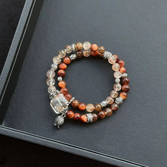 Healing crystal bracelet featuring Black-Gold Super Seven, Sun Tiger’s Eye, and Copper Rutilated Quartz – supports manifestation, energy strength, and grounding.
