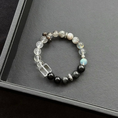 Healing crystal bracelet featuring Clear Quartz, Grey Moonstone, and Silver Obsidian – supports clarity, intuition, and energetic protection.
