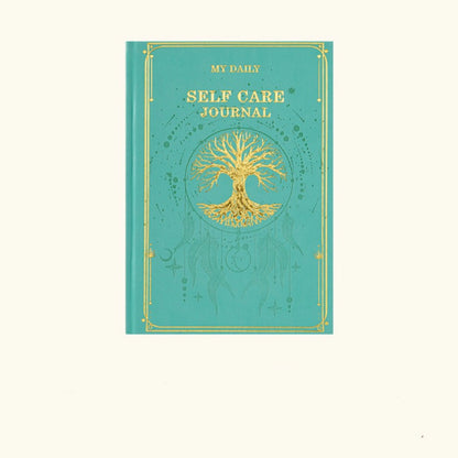 A deep emerald green aesthetic notebook decorated with traditional gold-tooled borders for meditation note-taking.