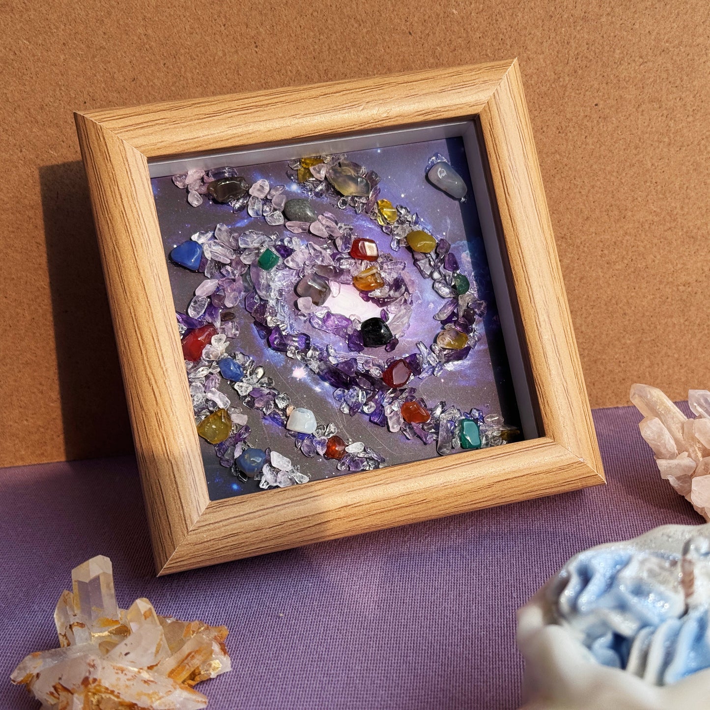 Handmade healing crystal art wall decor and premium gemstone home accessories displayed on a purple aesthetic desk.