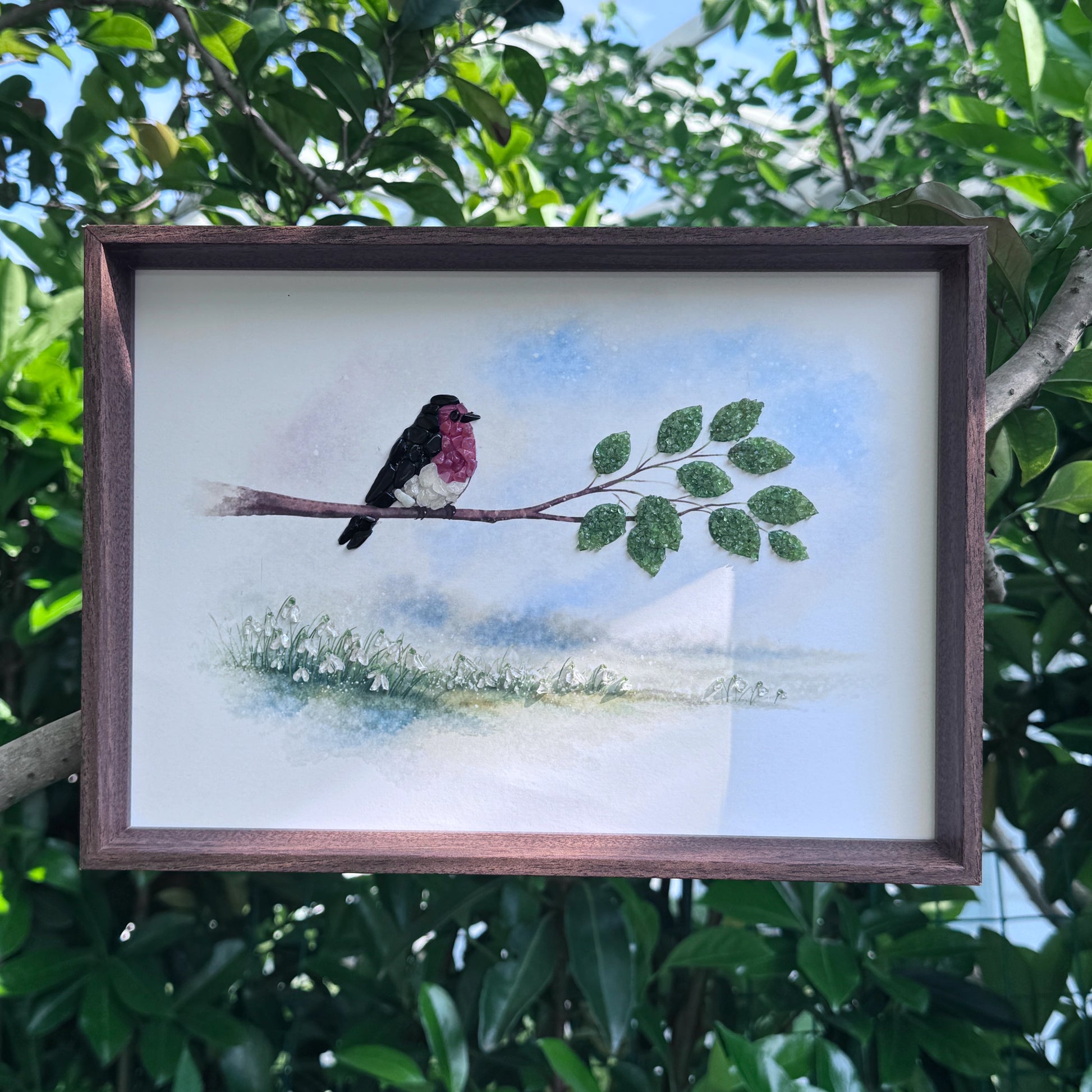 Healing crystal bird wall art displayed against a lush green garden background.