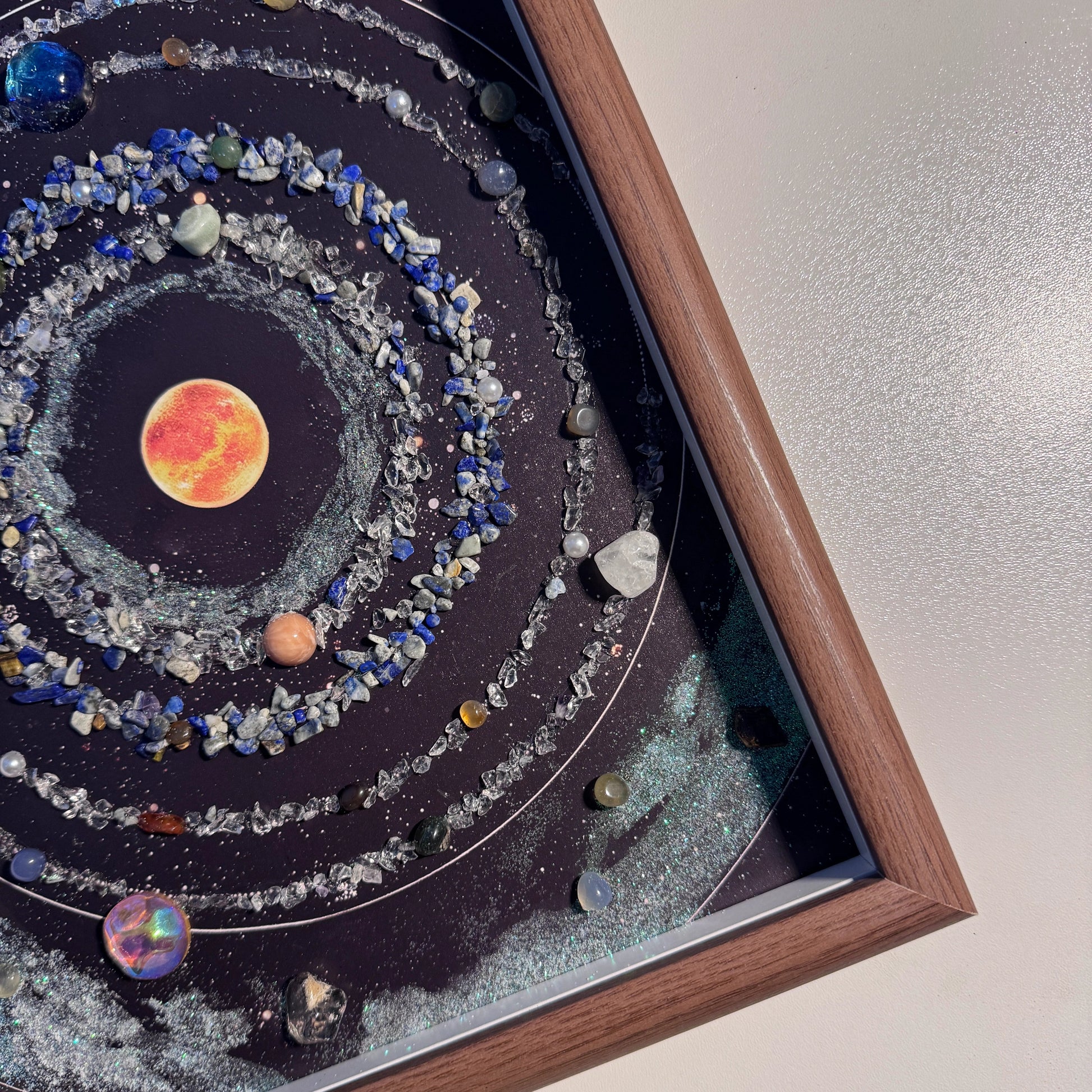 Detailed view of the central sun and Lapis Lazuli gemstone orbits in the healing crystal art.