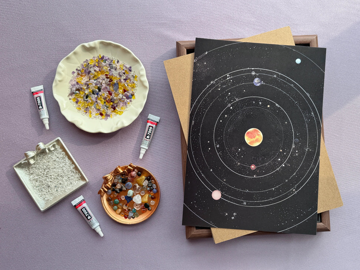 Aesthetic flatlay of the crystal galaxy kit with gemstones in decorative bowls and glue tubes.