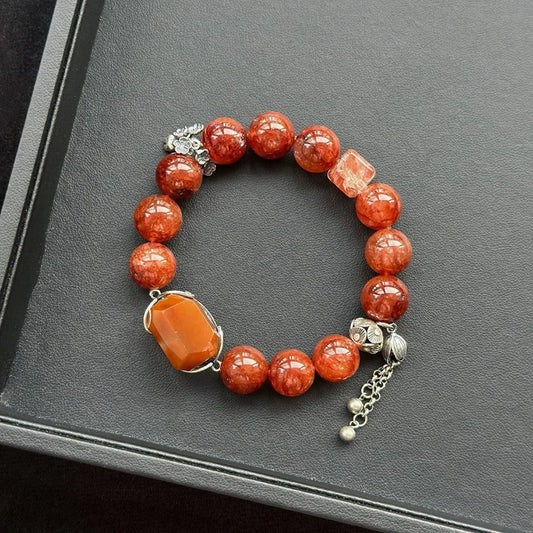 Healing crystal bracelet featuring Orange Rabbit Hair Quartz and Red Hematoid Quartz – supports vitality, grounding, and emotional strength.
