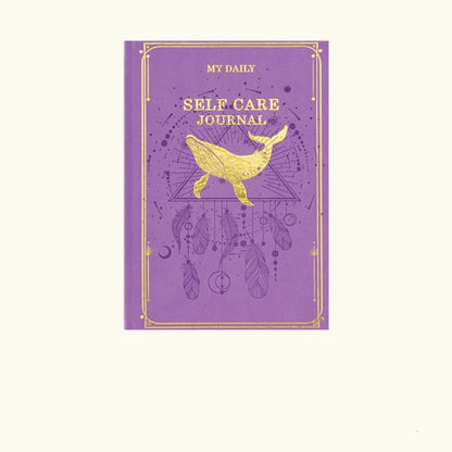 A regal purple spiritual room aesthetic notebook with a bright gold central starburst medallion design.