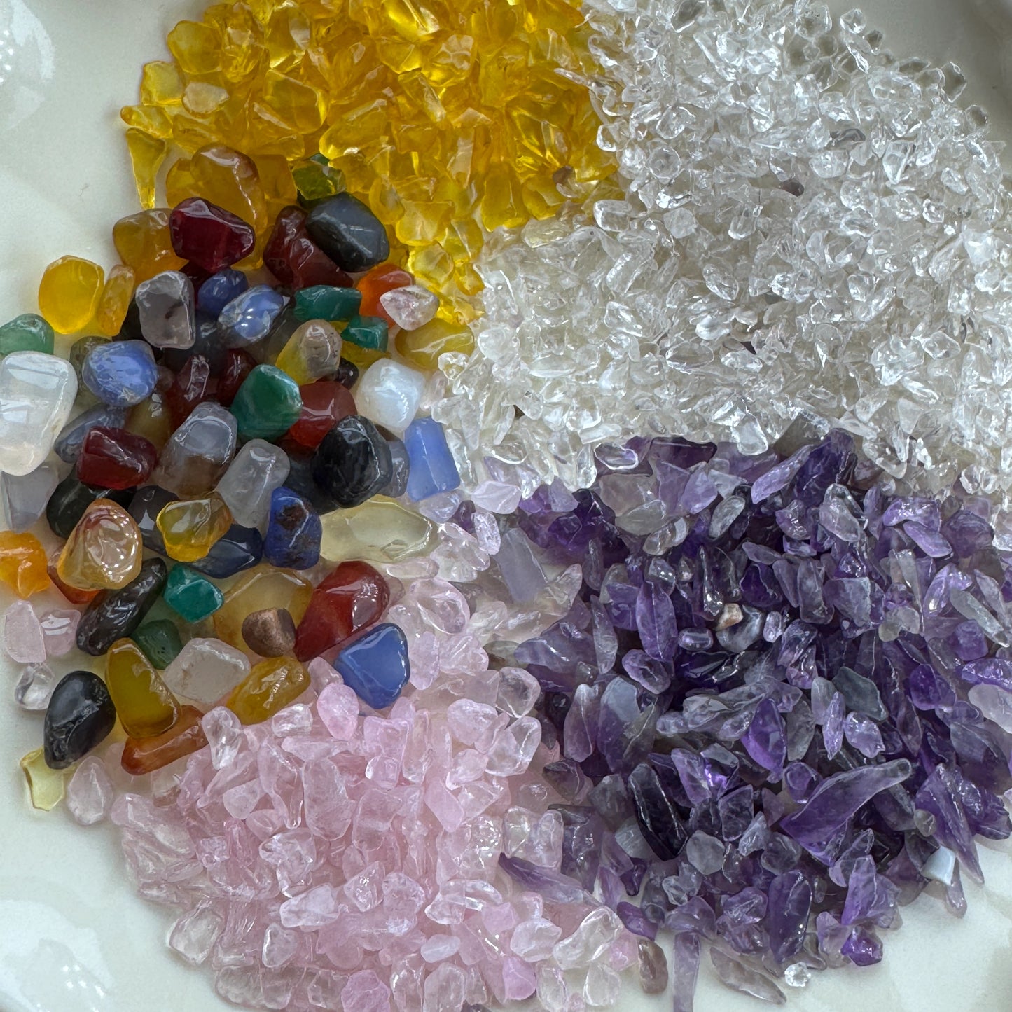 Macro shot of diverse natural healing stone chips and colorful gemstone fragments for DIY art.