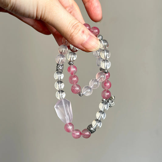 Beaded crystal bracelet made with Rose Quartz, Rhodonite, and Clear Quartz – promotes inner peace and emotional strength.