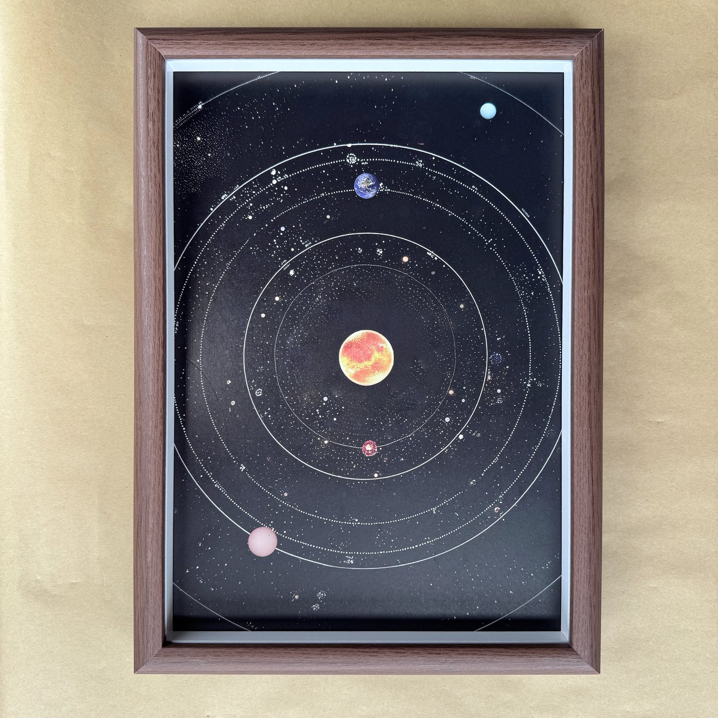 Close-up of the rectangular solar system canvas inside a wood-grain frame for DIY crystal art.