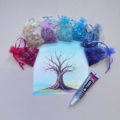 Square Tree of Life canvas art surrounded by colorful raw gemstone chips and a 15ml B-7000 adhesive tube for a mindful DIY crystal craft.