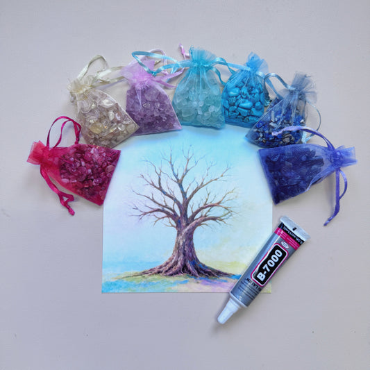 Square Tree of Life canvas art surrounded by colorful raw gemstone chips and a 15ml B-7000 adhesive tube for a mindful DIY crystal craft.