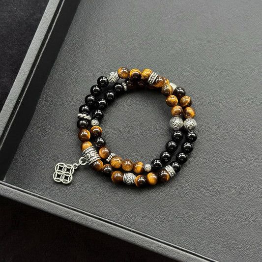 Healing crystal bracelet featuring Tiger’s Eye and Black Agate – for protection, courage, and emotional grounding.