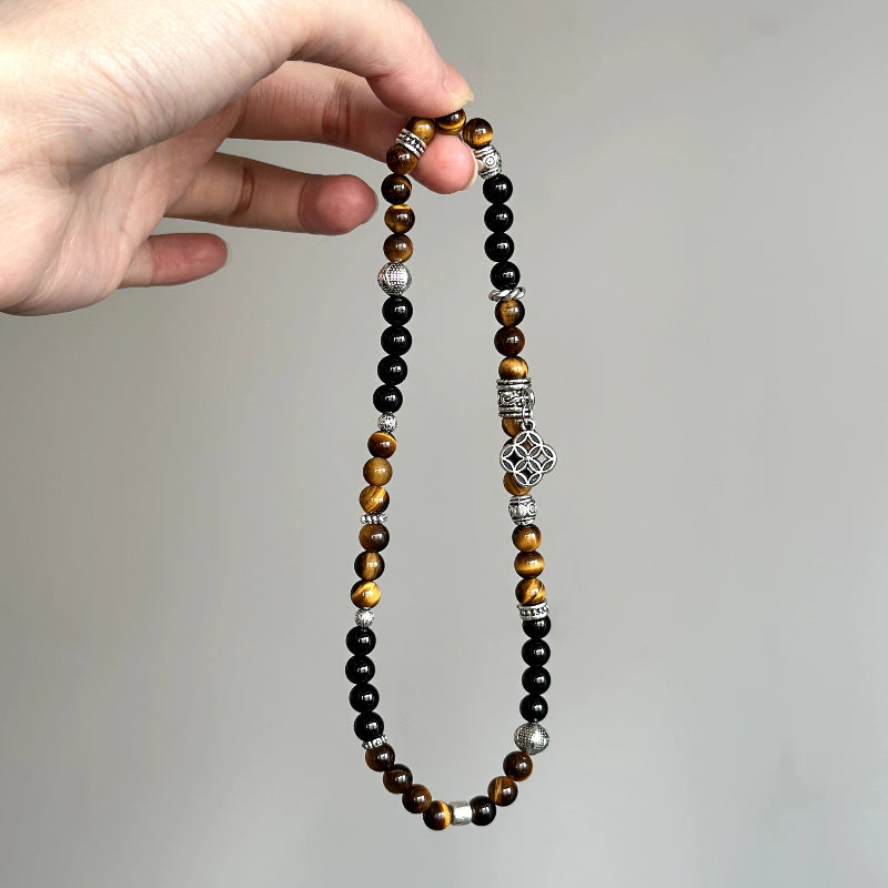 Beaded crystal bracelet made with Tiger’s Eye and Black Agate – ideal for energy protection and personal empowerment.