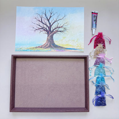 Flatlay view of the complete Tree of Life Crystal Art Kit featuring an A4 wood-grain frame, pre-printed canvas, 7 rainbow gemstone bags, and a 15ml adhesive tube.
