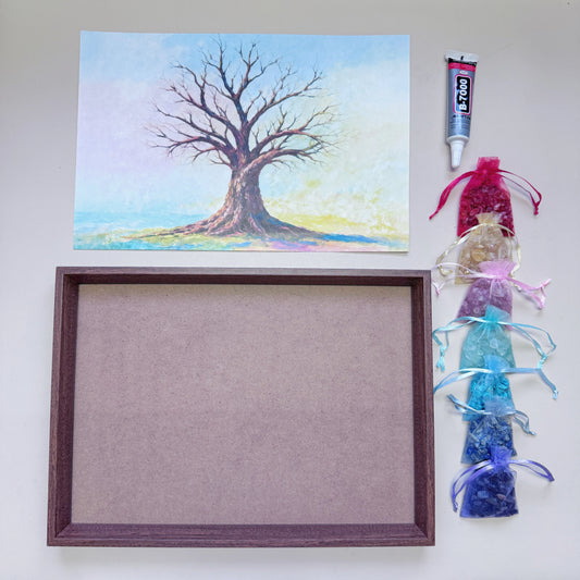 Flatlay view of the complete Tree of Life Crystal Art Kit featuring an A4 wood-grain frame, pre-printed canvas, 7 rainbow gemstone bags, and a 15ml adhesive tube.
