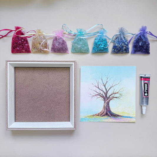 Flatlay view of the 15x15 cm (6 inch) square Tree of Life Crystal Art Kit featuring a wood-grain frame, canvas, 7 rainbow gemstone bags, and adhesive.